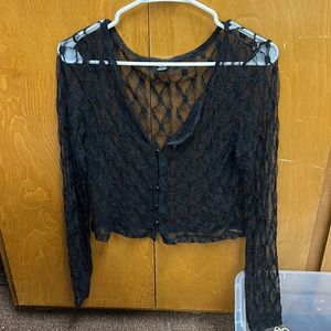 Black, lacy, long sleeved crop blouse.